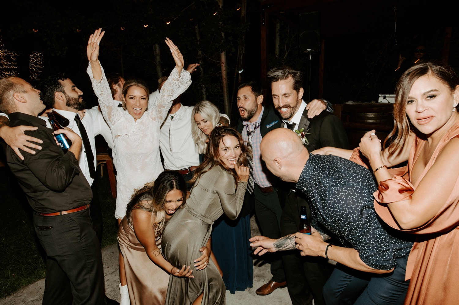 Joan and Kyle's guests dancing with their arms in the air
