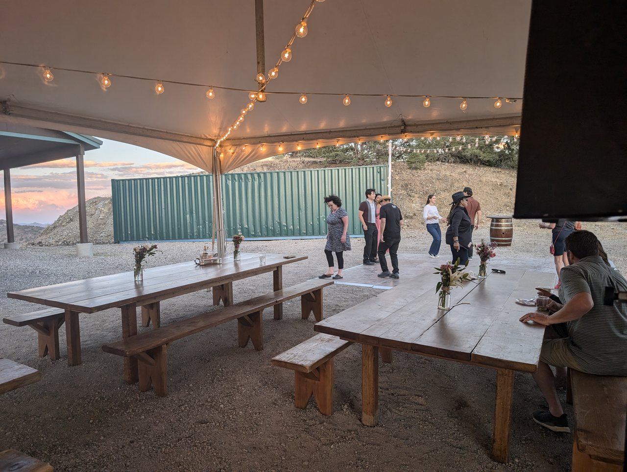 Guests dancing under the string lights of the tent at Alice’s 60th birthday in the Virginia City Highlands