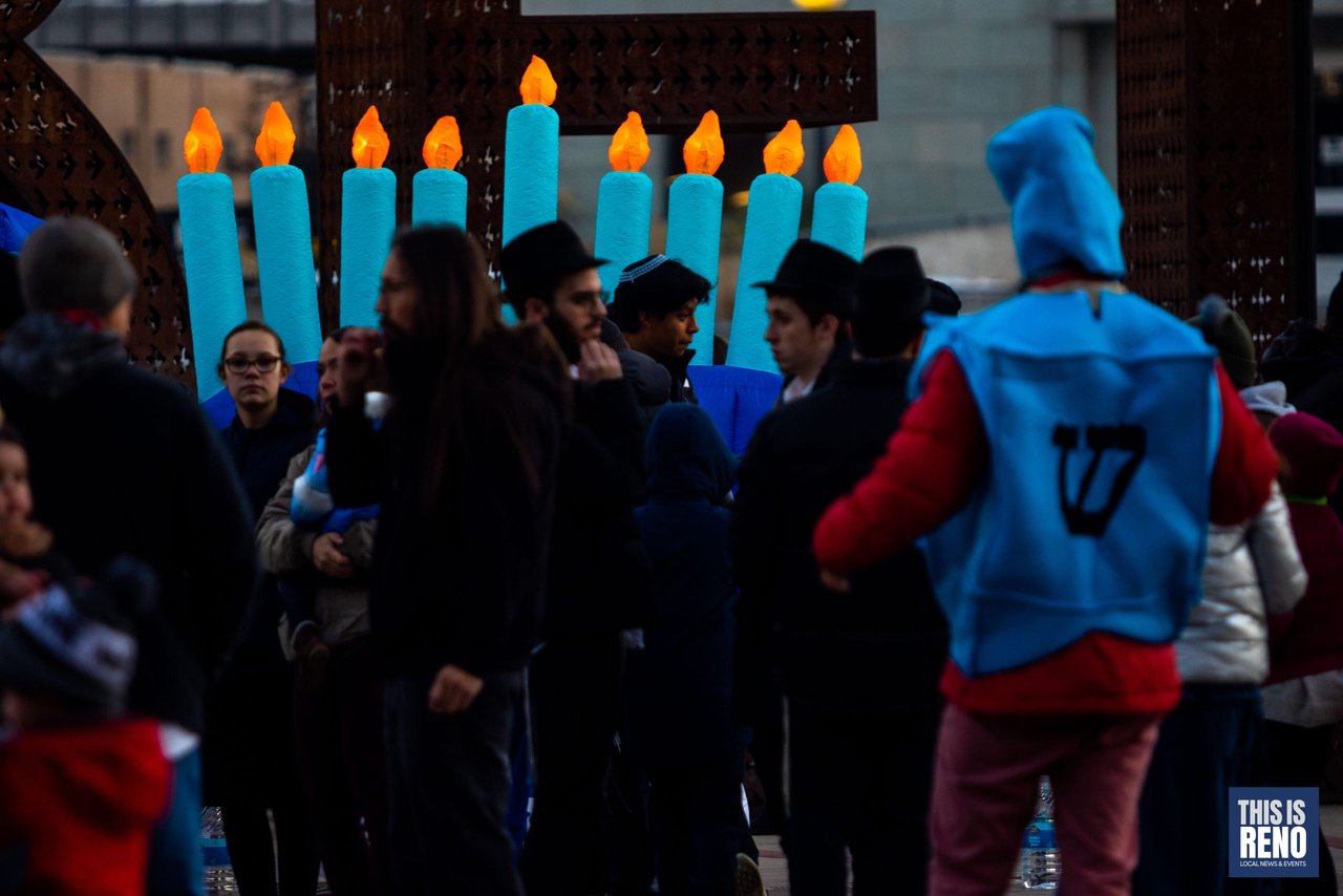 Families gather beside the giant inflatable candles