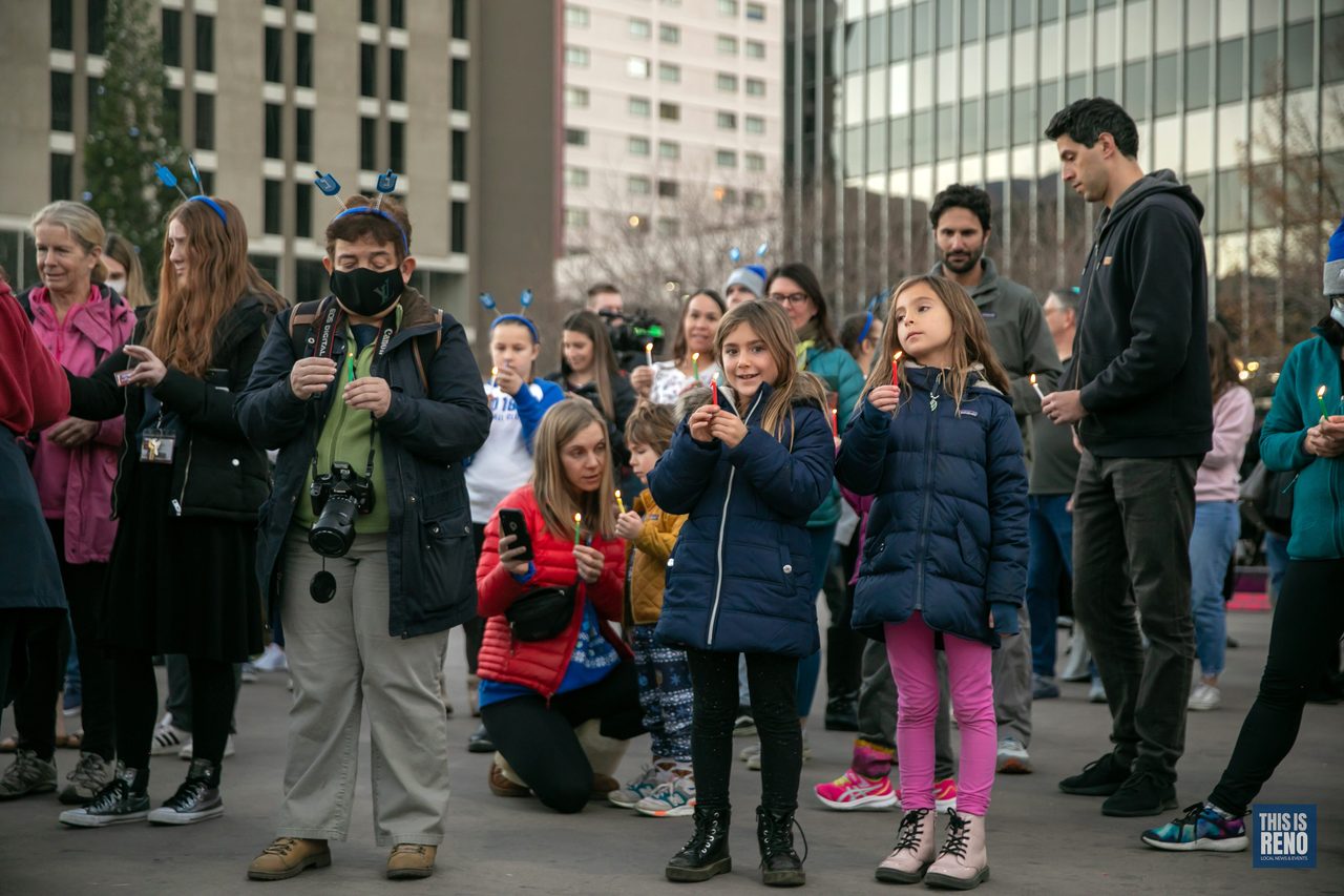 Kids and parents waiting for the lighting with candles in hand