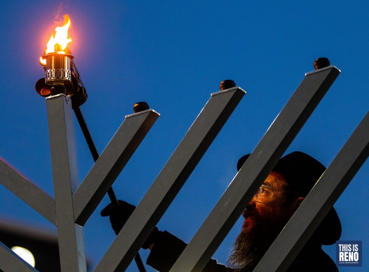 Rabbi Mendel Cunin lights the first candle on the City Plaza menorah