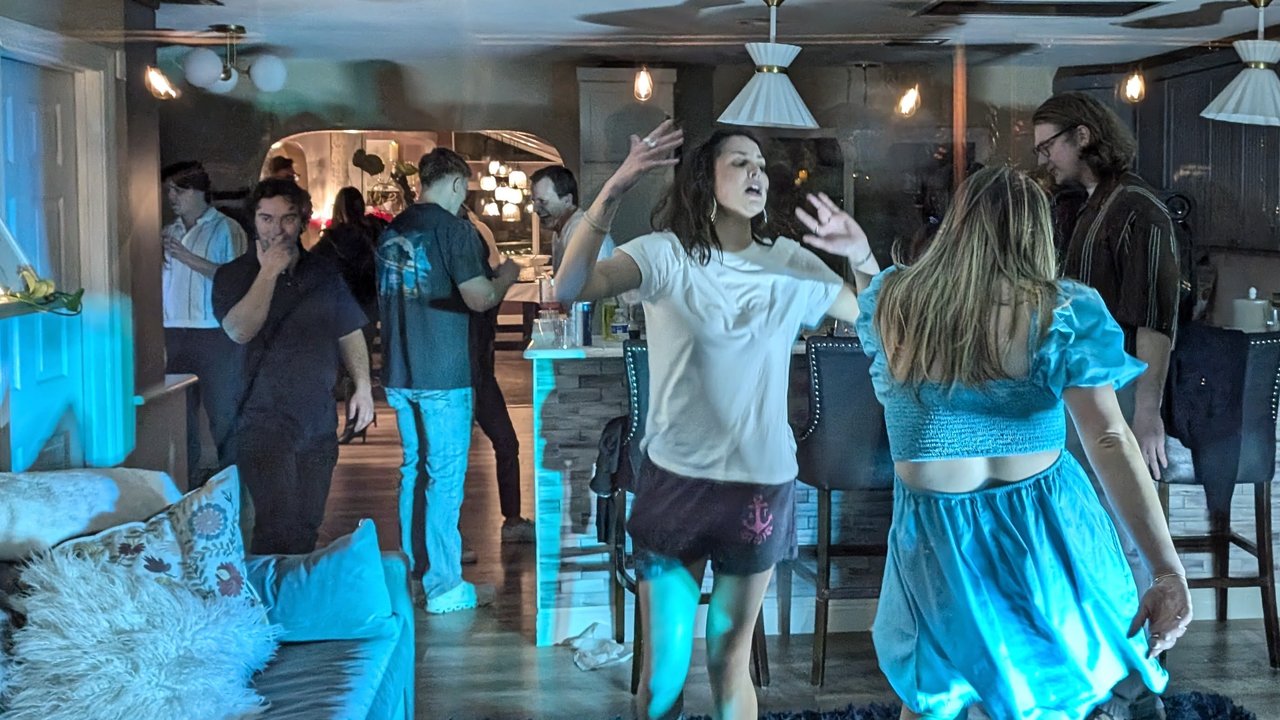 Guests dancing and singing in the living room at Niki’s 55th birthday party