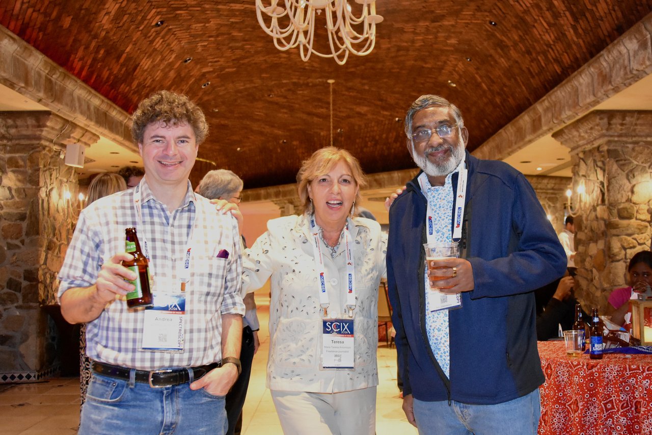 Three SciX Gala guests with drinks in the ballroom