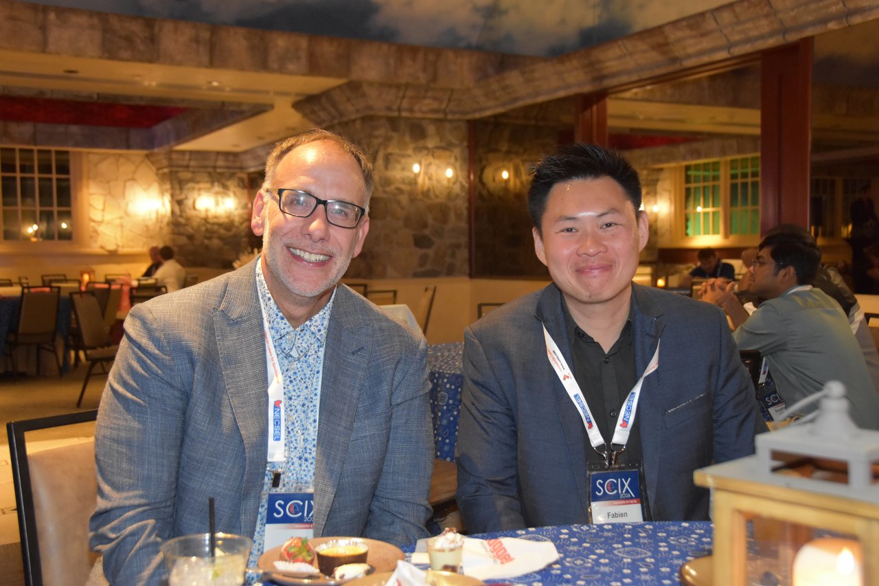 Two SciX Gala guests smiling at a gala table