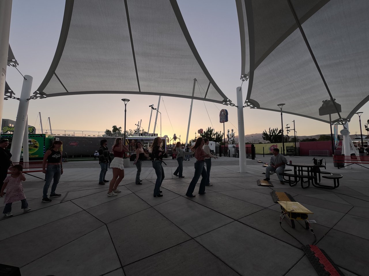 Line dancers under the shade sails at the Wanderlust Foodtrucks Festival