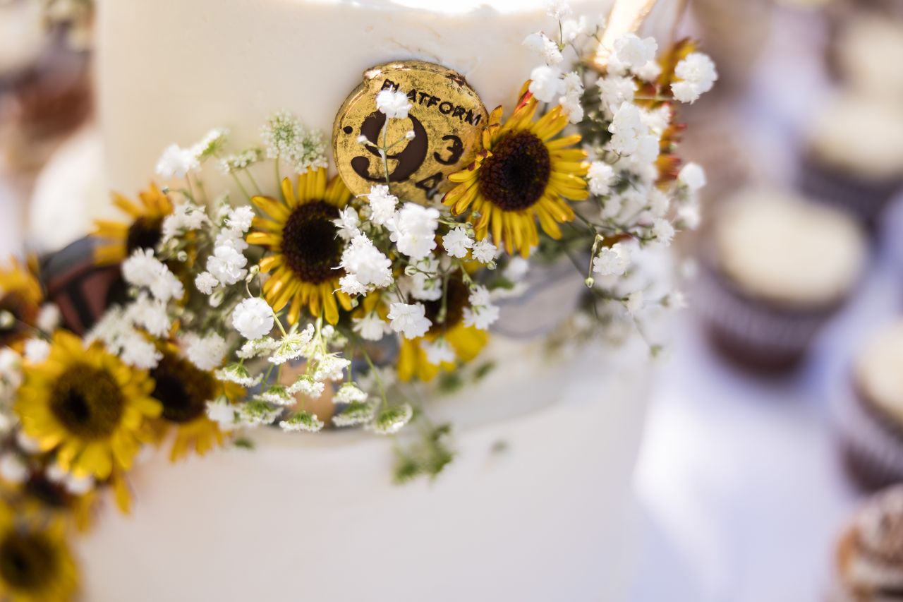 A close view of the cake's sunflowers and its Platform 9 3/4 emblem