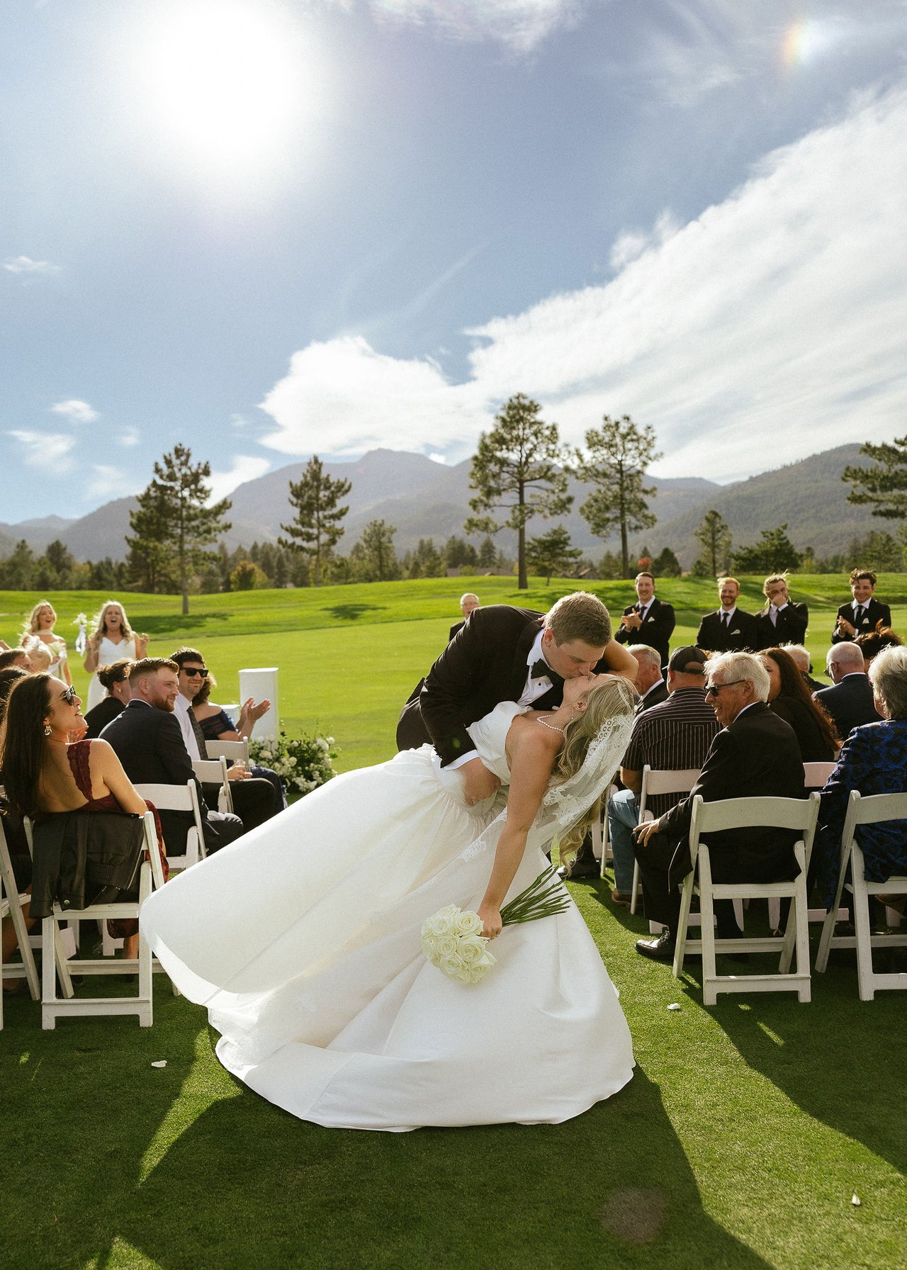 Drew dips Ally for a kiss in the aisle as their guests cheer