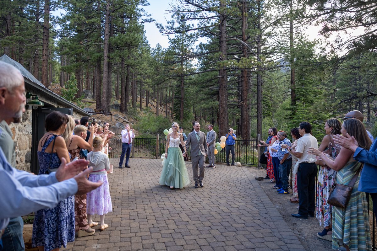 Guests cheering as Amy and Justin walk back up the aisle after their ceremony