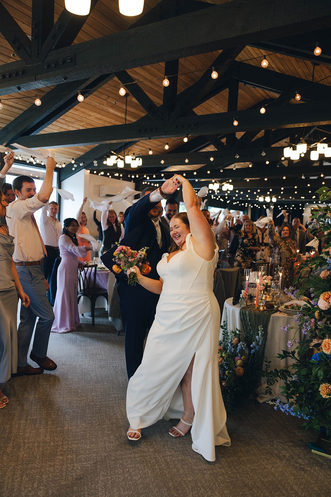 Autumn twirls and laughs between the tables at the grand entrance while guests wave napkins