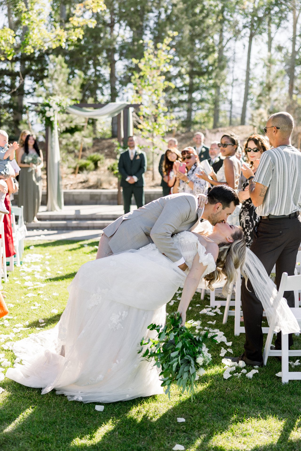 Chris dips Britt in the aisle as guests cheer