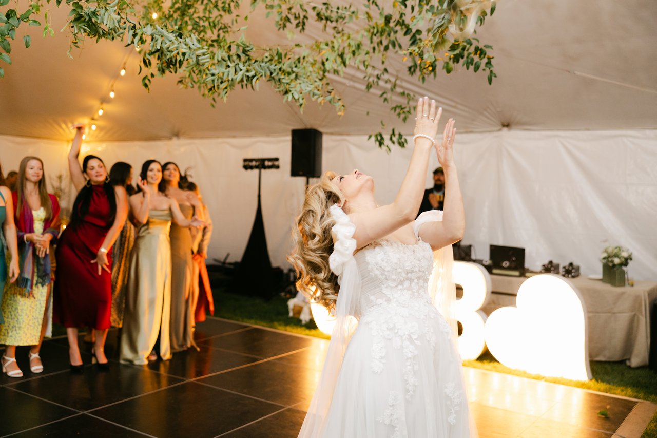 Britt tosses her bouquet to her friends