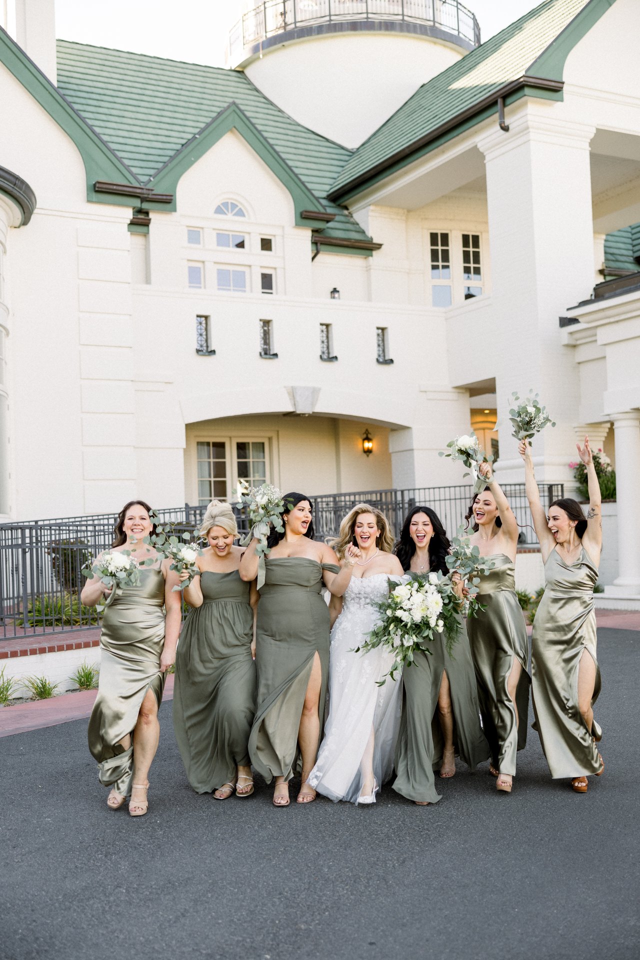 Britt and her bridesmaids cheer with their bouquets raised