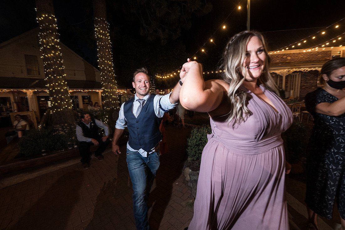 Friends dancing together under the string lights