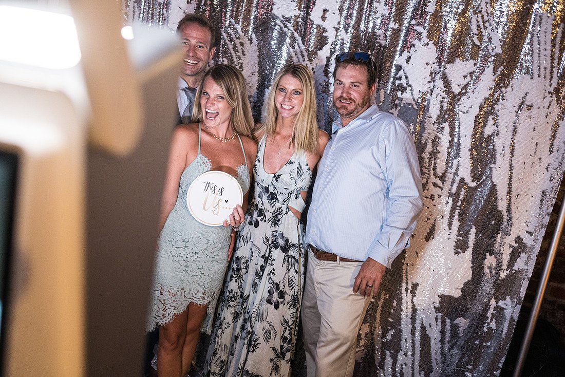 Friends pose together at the photo booth