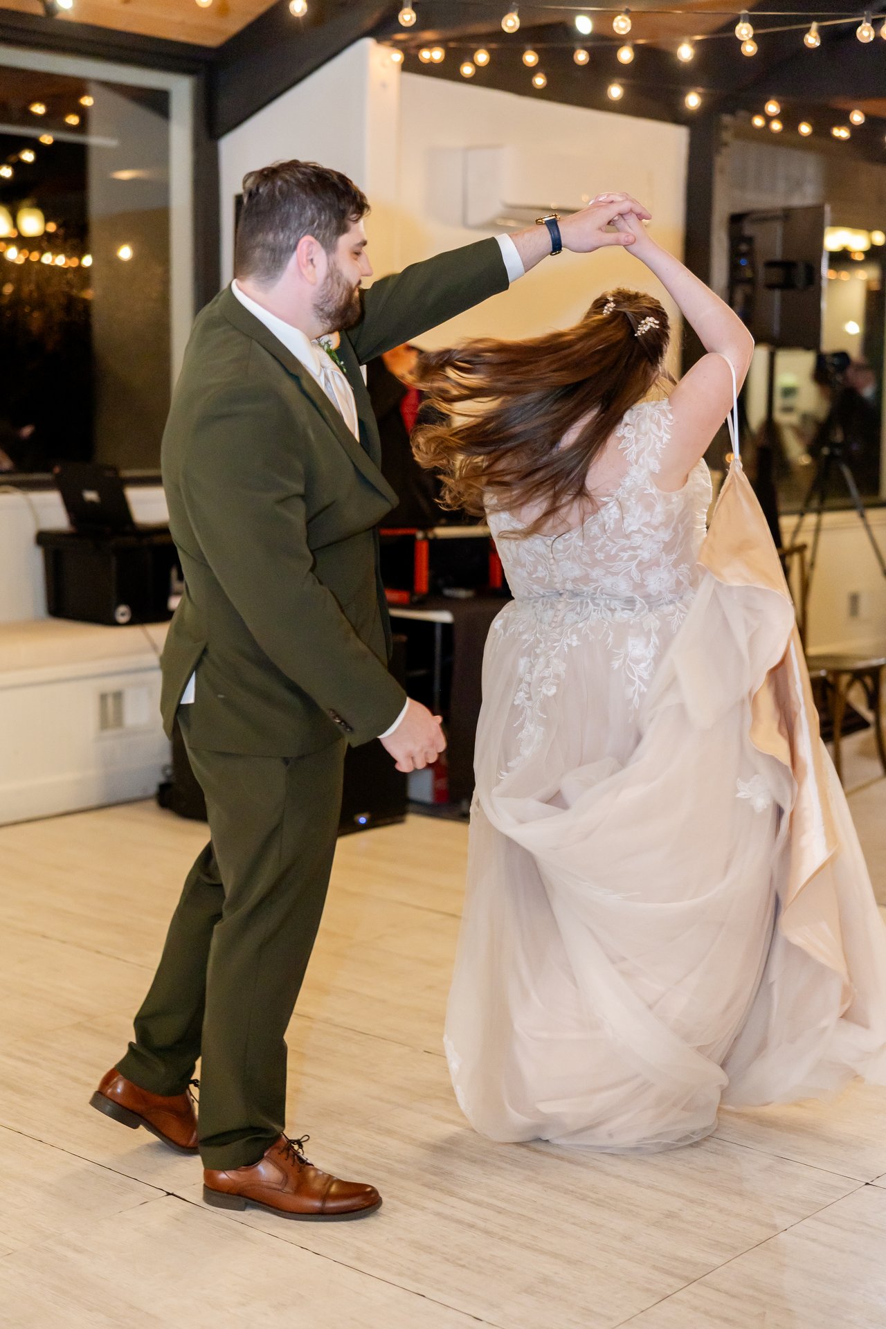 Brandon twirls Danielle during their first dance, her hair flying