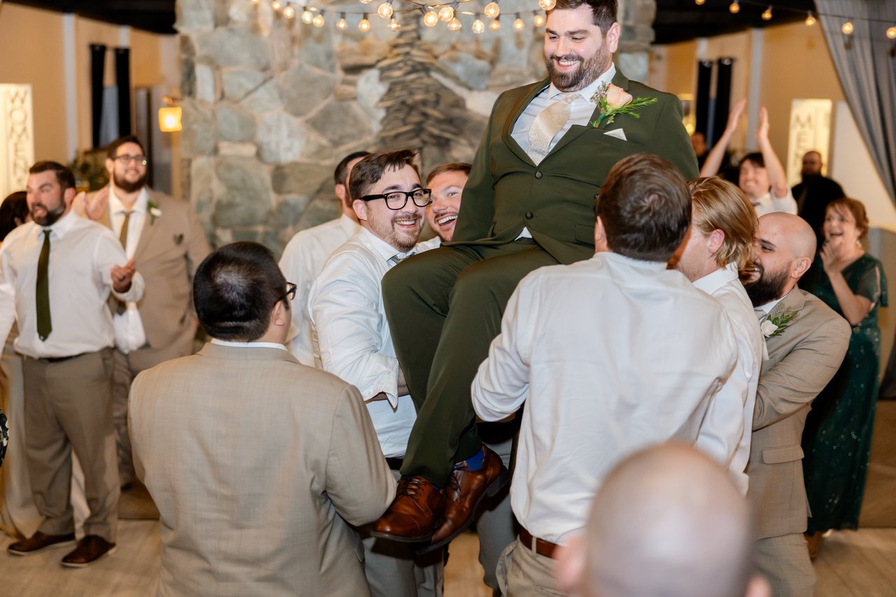 Guests lift Brandon high in a chair