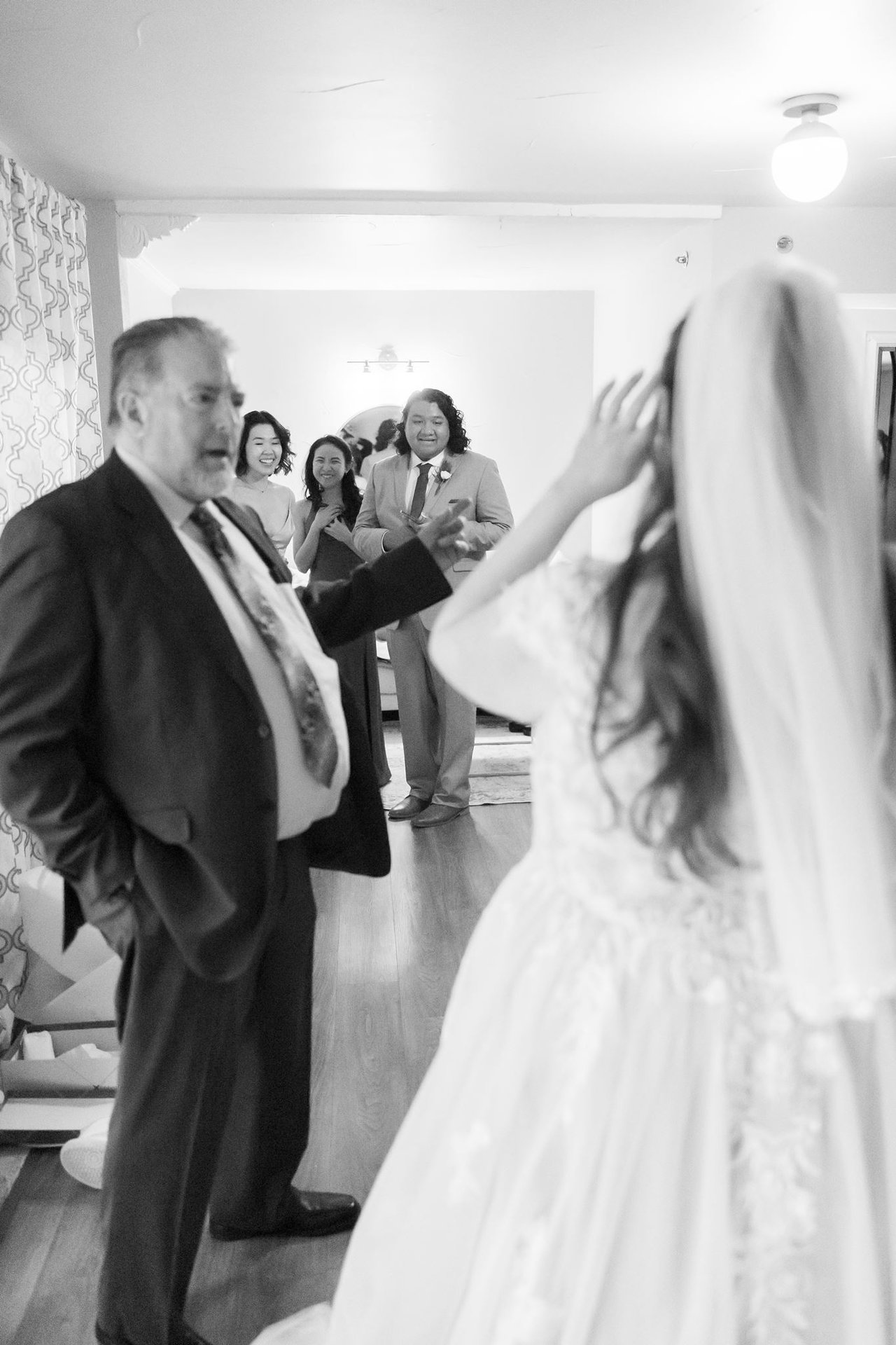 A black and white photo of Danielle's dad seeing her in her gown for the first time