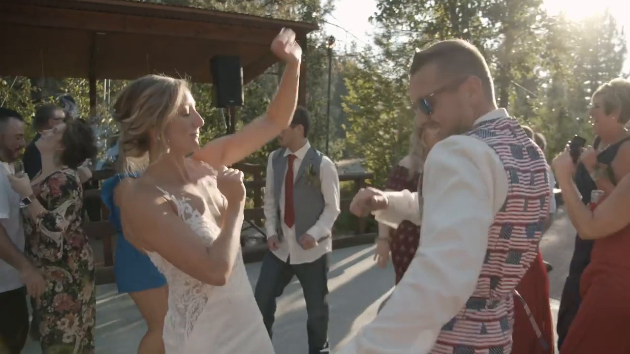 Danielle and Scott dance with guests under the patio cover