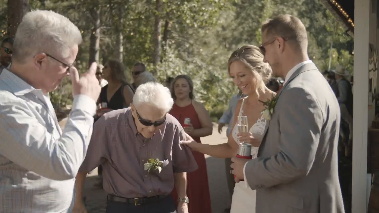 Danielle and Scott greet older family members on the patio