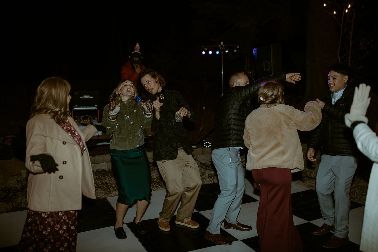 Guests dance together on the checkered floor