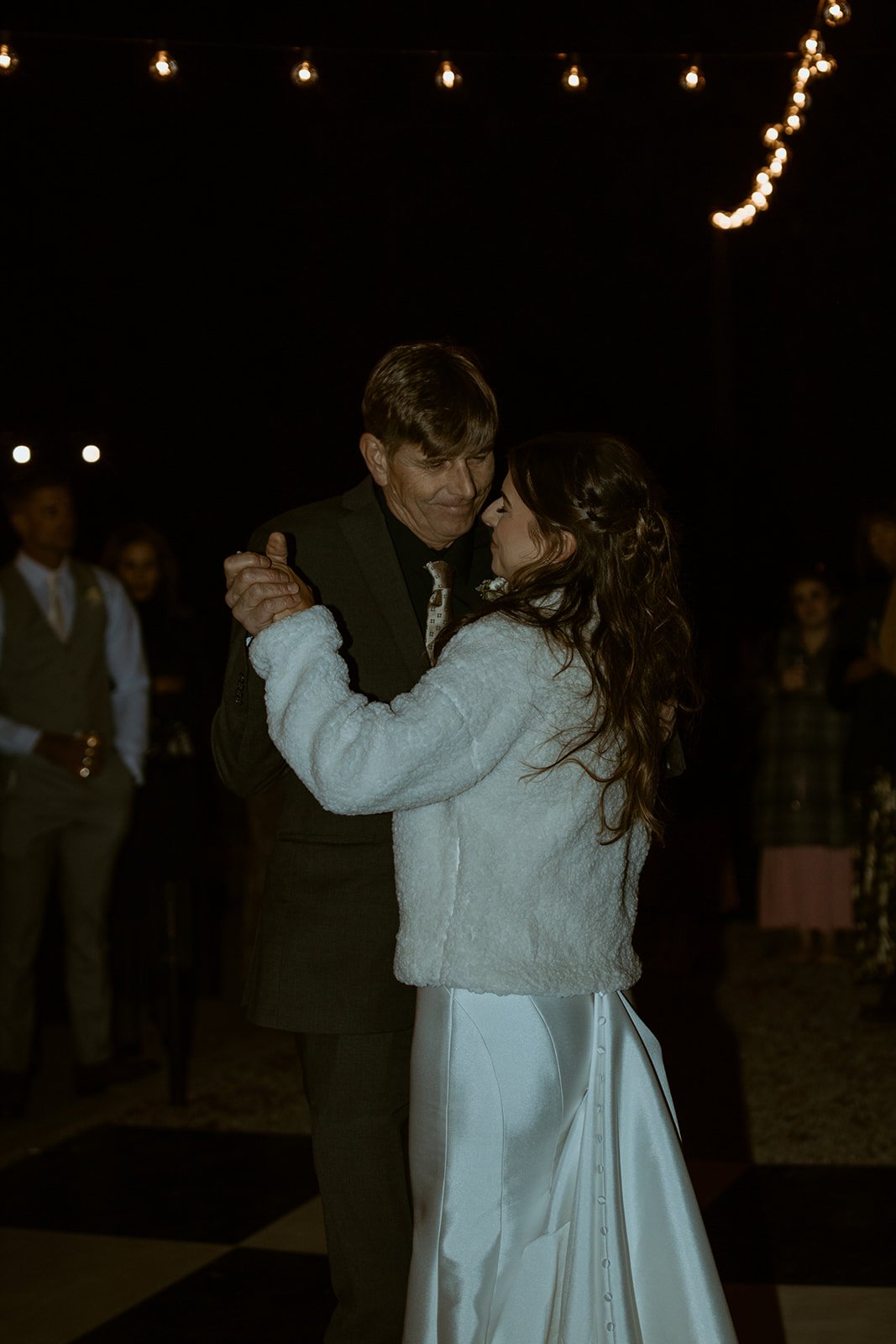 Emily and her father dance cheek to cheek