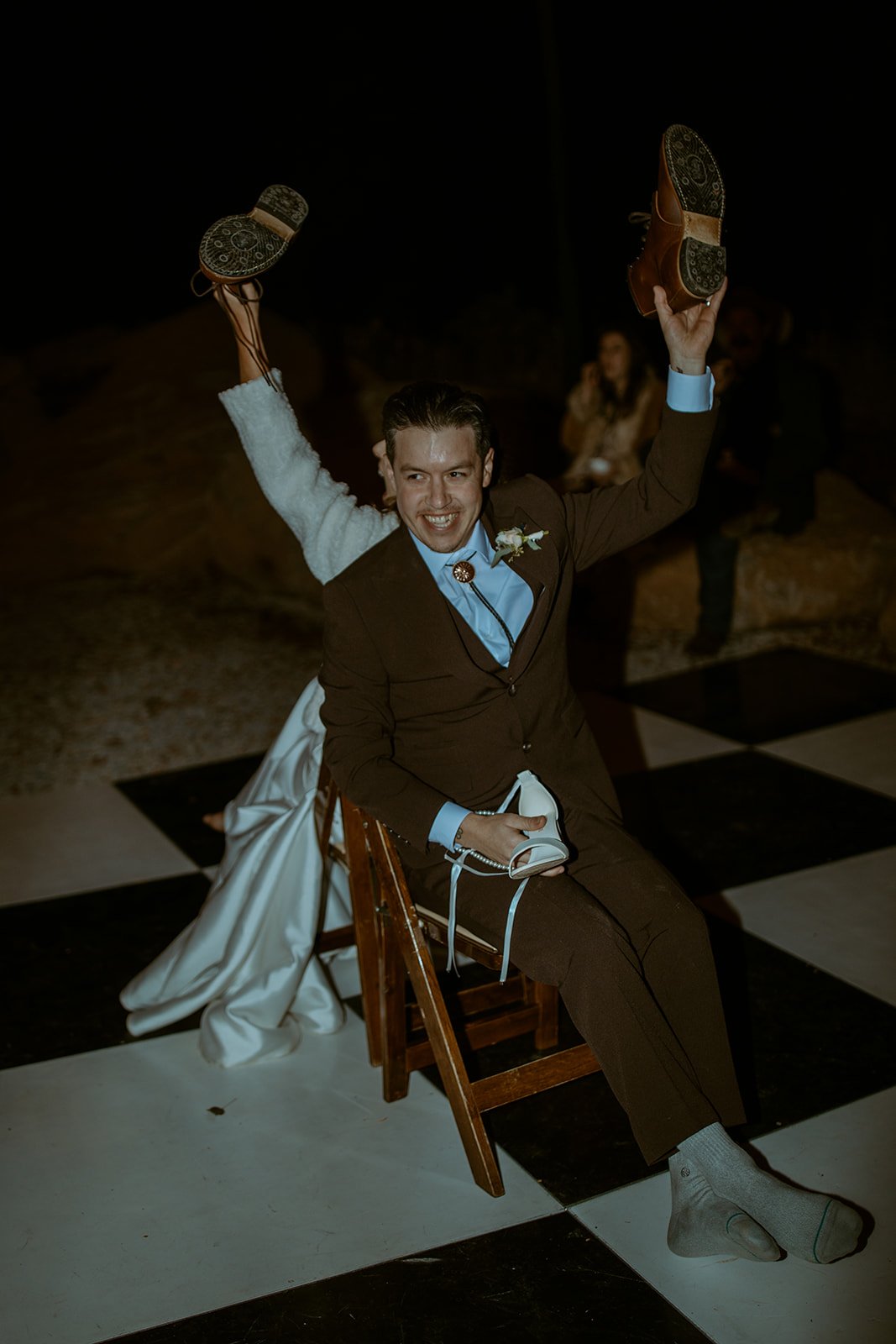 Devin laughs with both shoes in the air during the shoe game