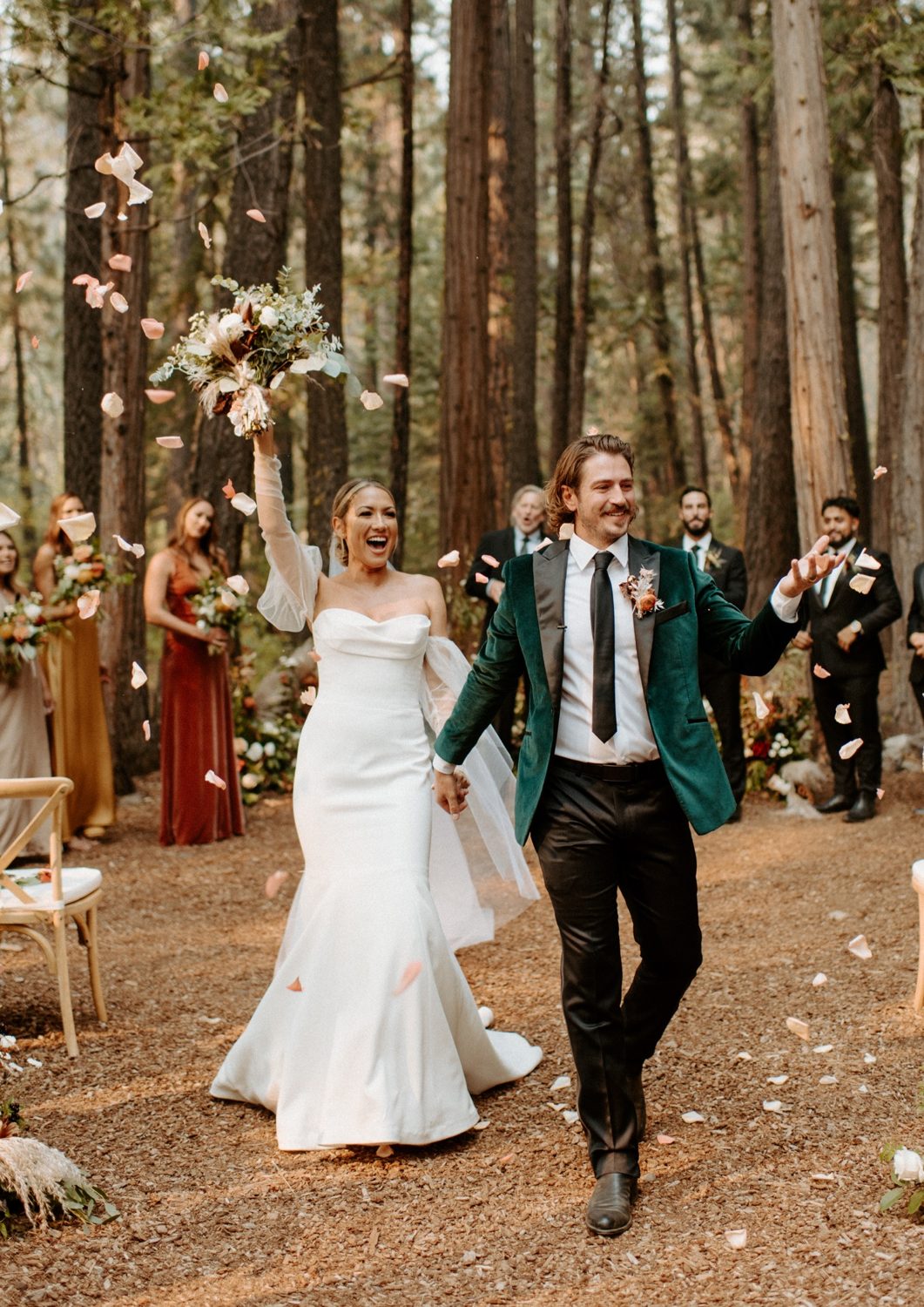 Joan and Kyle celebrate as they walk back up the aisle at Twenty Mile House, Graeagle