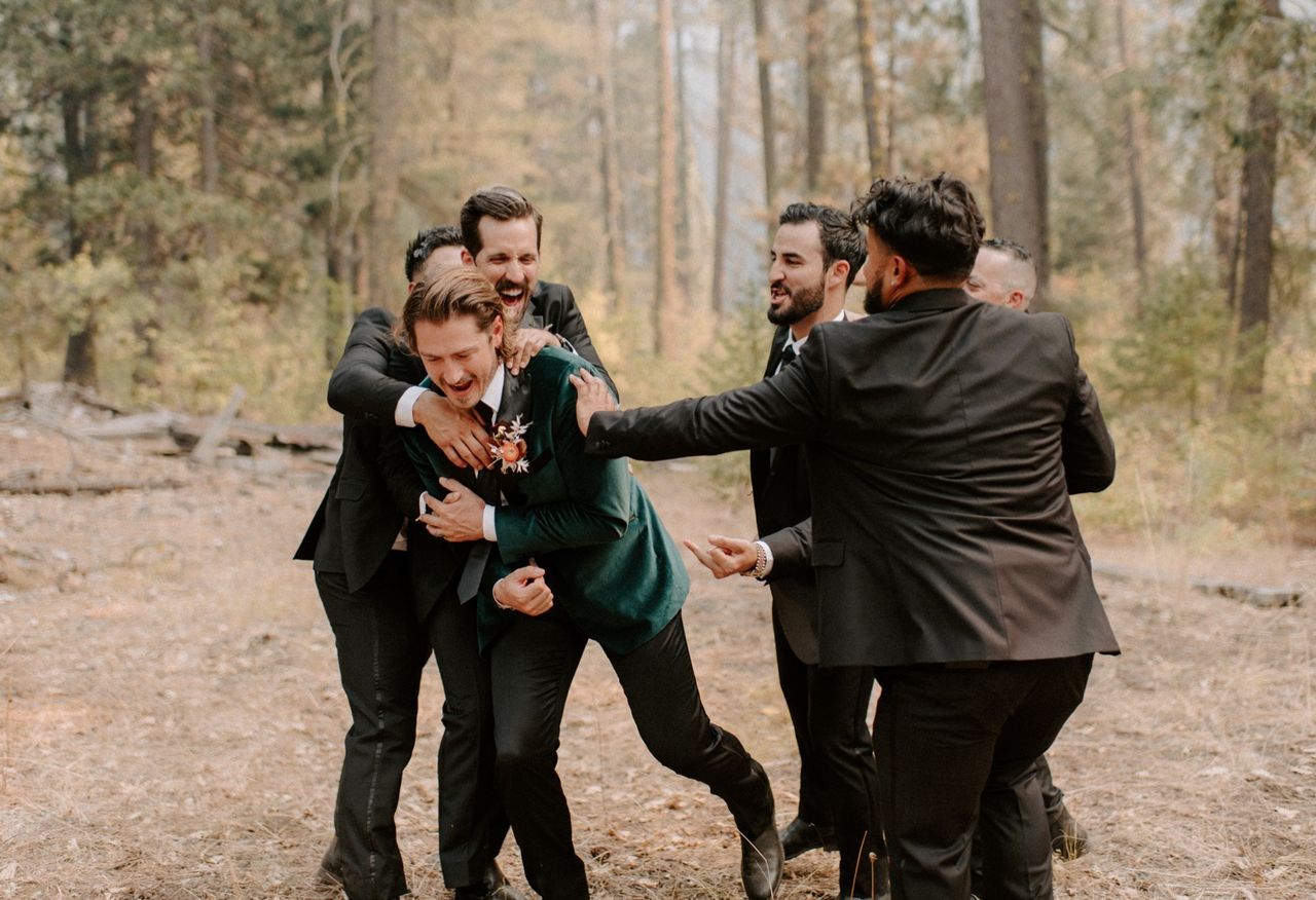 Kyle's groomsmen pull him into a hug