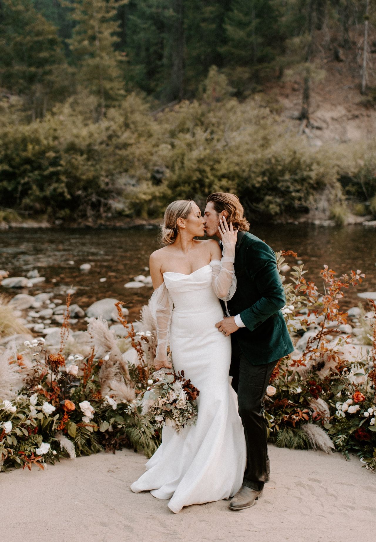 Joan and Kyle kiss by the river
