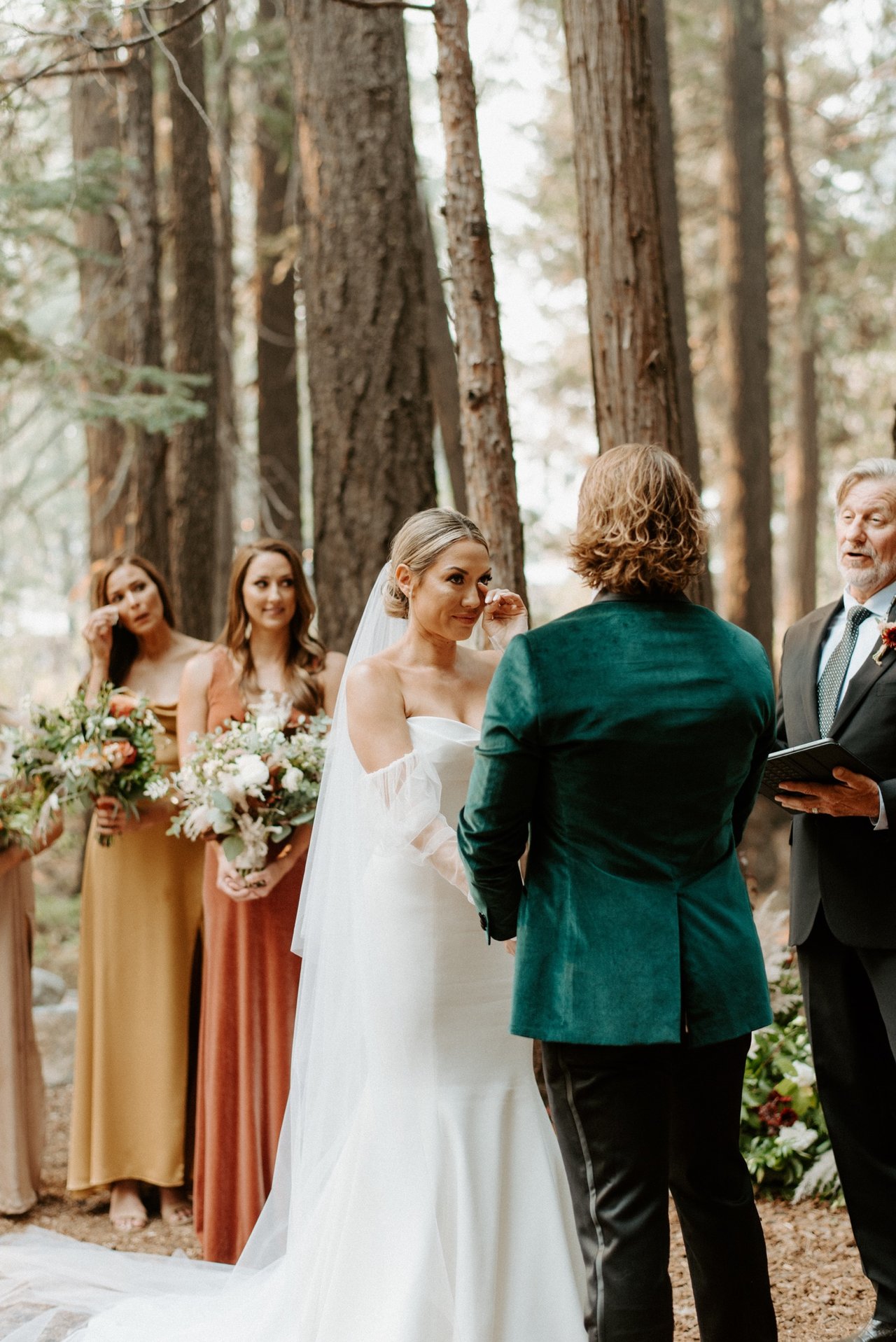 Joan faces Kyle at the altar, seen over his shoulder, her bridesmaids beside her