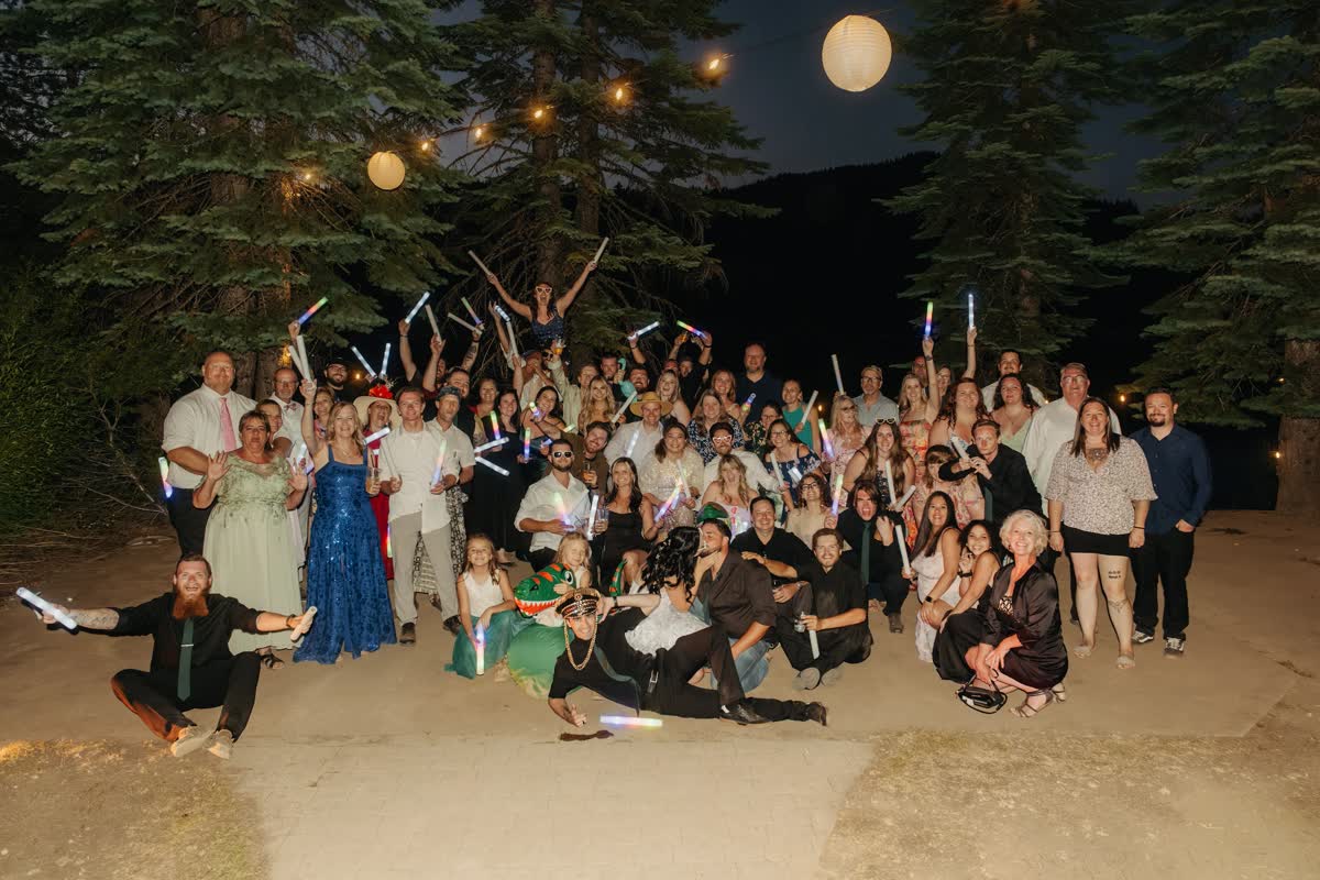 The whole wedding party poses with glow sticks at Kaitlyn and Tristan's Lakeshore Resort reception