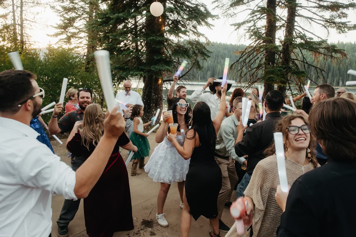 Guests wave glow sticks on the dance floor at Kaitlyn and Tristan's Bucks Lake wedding