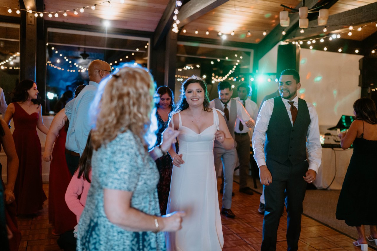 Montse and Jason dance in the middle of a crowded dance floor