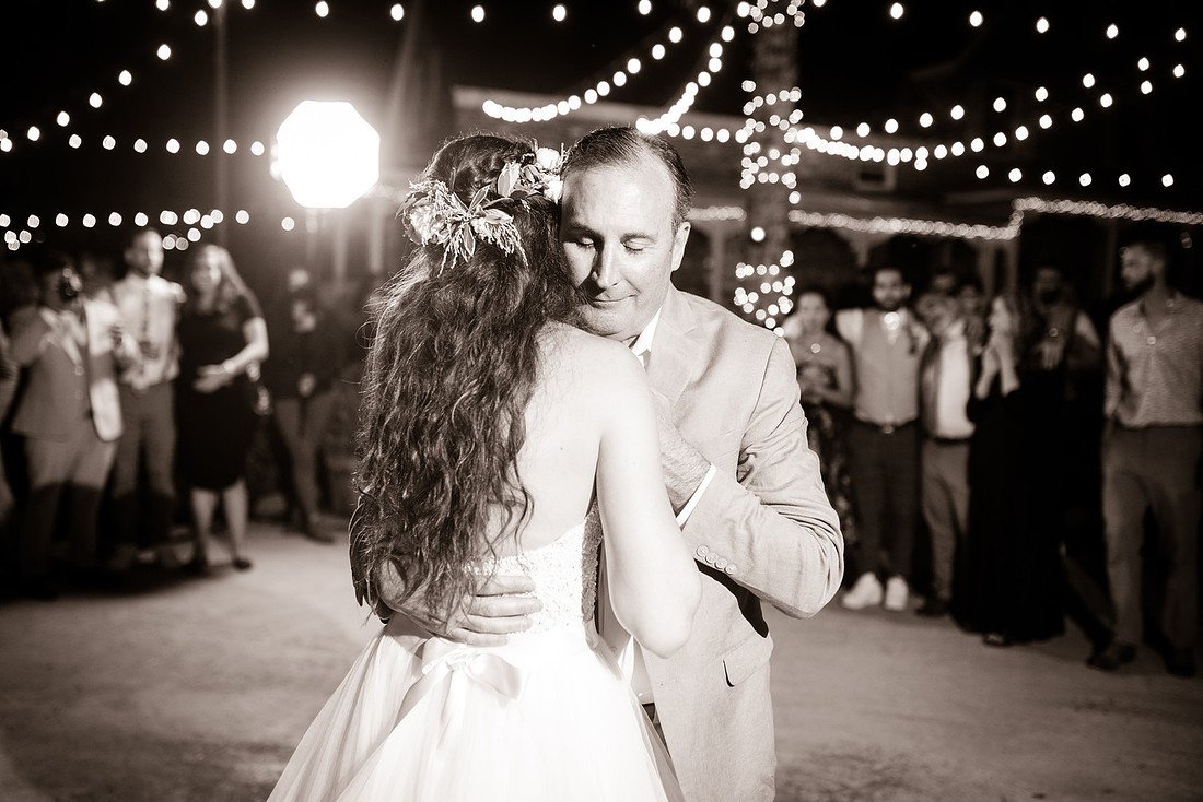 Shannon dances with her father as guests watch