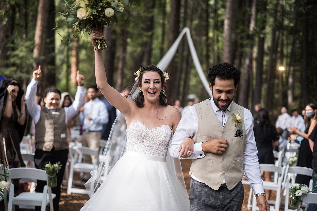 Shannon throws her bouquet up in the air as she and Ryan walk back up the aisle