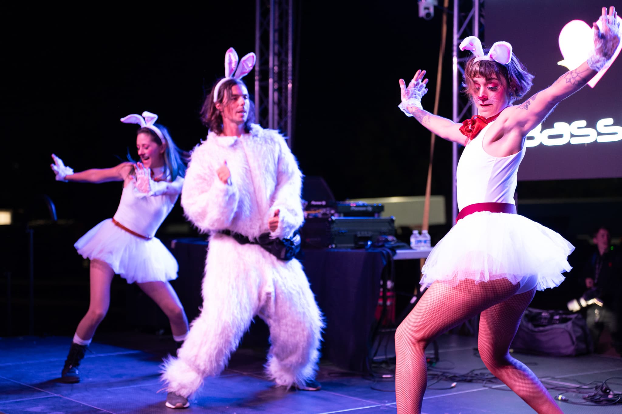 Dancers in bunny ears performing on stage at CMYK Festival in Rancho San Rafael Park