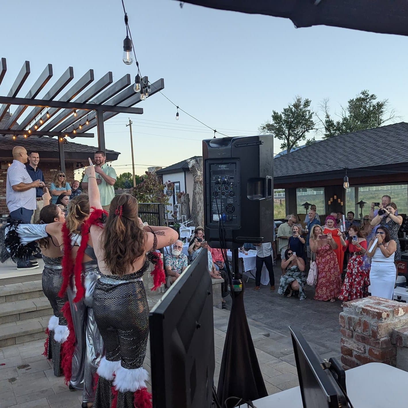 Guests singing karaoke on the patio at Alex and Jacob's wedding party in Reno